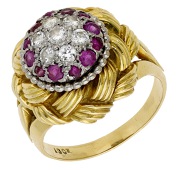 A mid 20th century ruby and diamond dress ring, of plaited design, to a central cluster of circular-cut rubies and...