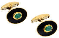 A pair of 18ct gold, enamel and emerald cufflinks by Deakin & Francis, the black enamelled oval panels with applied...