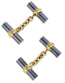 A pair of 18ct gold and hematite cufflinks by Deakin & Francis, 1994, the polished hematite batons with central...