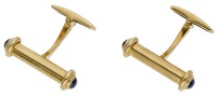 A pair of 18ct gold and sapphire cufflinks, 1992, the baton terminals set with sapphire cabochons, to hinged T-bar...
