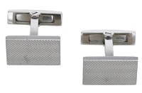 A pair of silver cufflinks by A M Designs for Cartier, the rectangular panels with repeating chevron decoration,...