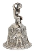 A Victorian silver table bell, cast with a circle of cherubs holding wreaths on a textured ground, the handle...