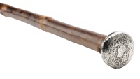 A late 19th century Aesthetic movement silver topped cane, the finial worked with a rabbit amidst lily plants,...