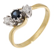 A sapphire and diamond ring, of crossover design, set with a circular-cut sapphire between brilliant-cut diamonds,...