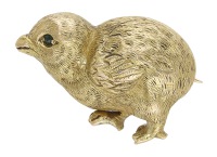 An antique novelty chick brooch, realistically modelled with engraved textured feathers and gem-set eye, mounted in...