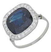 An early 20th century sapphire and diamond cluster ring, the cushion-shaped sapphire within a surround of single-cut...