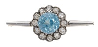 An early 20th century blue zircon and diamond bar brooch, the circular-cut blue zircon within a surround of old...