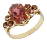 An 18ct gold and tourmaline dress ring, 1989, set with an oval mixed-cut tourmaline between shoulders set with...