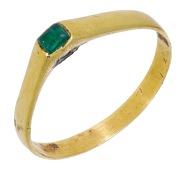 A Medieval gold and emerald stirrup ring, circa 13th century - early 14th century, the raised bezel inset with a...