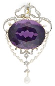 An amethyst, pearl and diamond brooch, circa 1900, the oval-cut amethyst within a swagged surround of seed pearls...