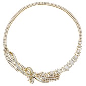 A diamond necklace, the frontispiece composed of stylised flowerheads with ribbon and swag detailing to one side,...