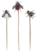 Three gem-set insect stickpins, all set with rose-cut diamonds and variously set with rubies, moonstone and a...