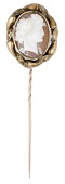 A late 19th century shell cameo stickpin, carved to depict a bacchante, within an entwined scrolled surround,...