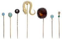 A collection of antique stickpins, comprising a pin set with an old brilliant-cut diamond of yellow tint with an...
