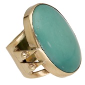 A turquoise ring by Barbara Cartlidge, 1964, the oval turquoise cabochon between openwork triangular shoulders with...