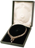A 9ct gold ‘Boyd’ necklace by David Thomas, 1964, of tapered crossover design, formed of vari-coloured polished...