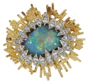An opal and diamond brooch by Grima, of bicolour starburst design, set with a black boulder opal cabochon, the...