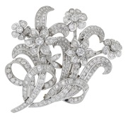 A mid 20th century diamond double-clip spray brooch, the flowerheads and interlaced foliage set throughout with...