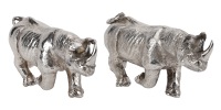 A pair of silver models of rhinoceroses by Silver Creations, realistically modelled at full charge, both stamped...