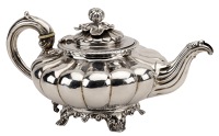 A William IV silver tea pot, of squat lobed form, leaf capped scroll handle and pomegranate finial, by John James...