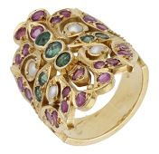 An Indian gem-set dress ring, the pierced foliate plaque set throughout with circular-cut emeralds and rubies with...