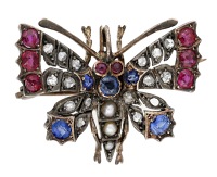 A gem-set butterfly brooch, circa 1890, set throughout with cushion and circular-cut rubies and sapphires, rose-cut...