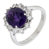 An amethyst and diamond ring by Tom O’Donoghue, set with an oval-cut amethyst within a surround of single-cut...