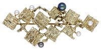 A cultured pearl brooch, circa 1970, formed of textured square-shaped plaques, with polished square highlights and...