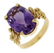 An amethyst dress ring, the oval-cut amethyst between knotted ropetwist shoulders, to a reeded hoop, ring size M.	...
