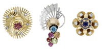 Three gem-set ear clips, the first sapphire and diamond clip, of flowerhead design set with circular-cut sapphires...