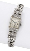 Swiss. A lady’s platinum and diamond-set cocktail watch, circa 1930.
Movement: manual winding, 17 jewels.
Dial:...