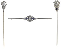 Three early 20th century jewels, comprising two diamond stick pins and a sapphire and diamond bar brooch, mounted in...
