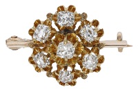 A diamond brooch, converted from a 19th century jewel, the flowerhead cluster set with old cushion-cut diamonds,...