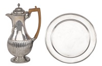 A Victorian silver hot water jug, with half lobed pear shaped body, London 1886, and a plain silver plate by Tiffany...